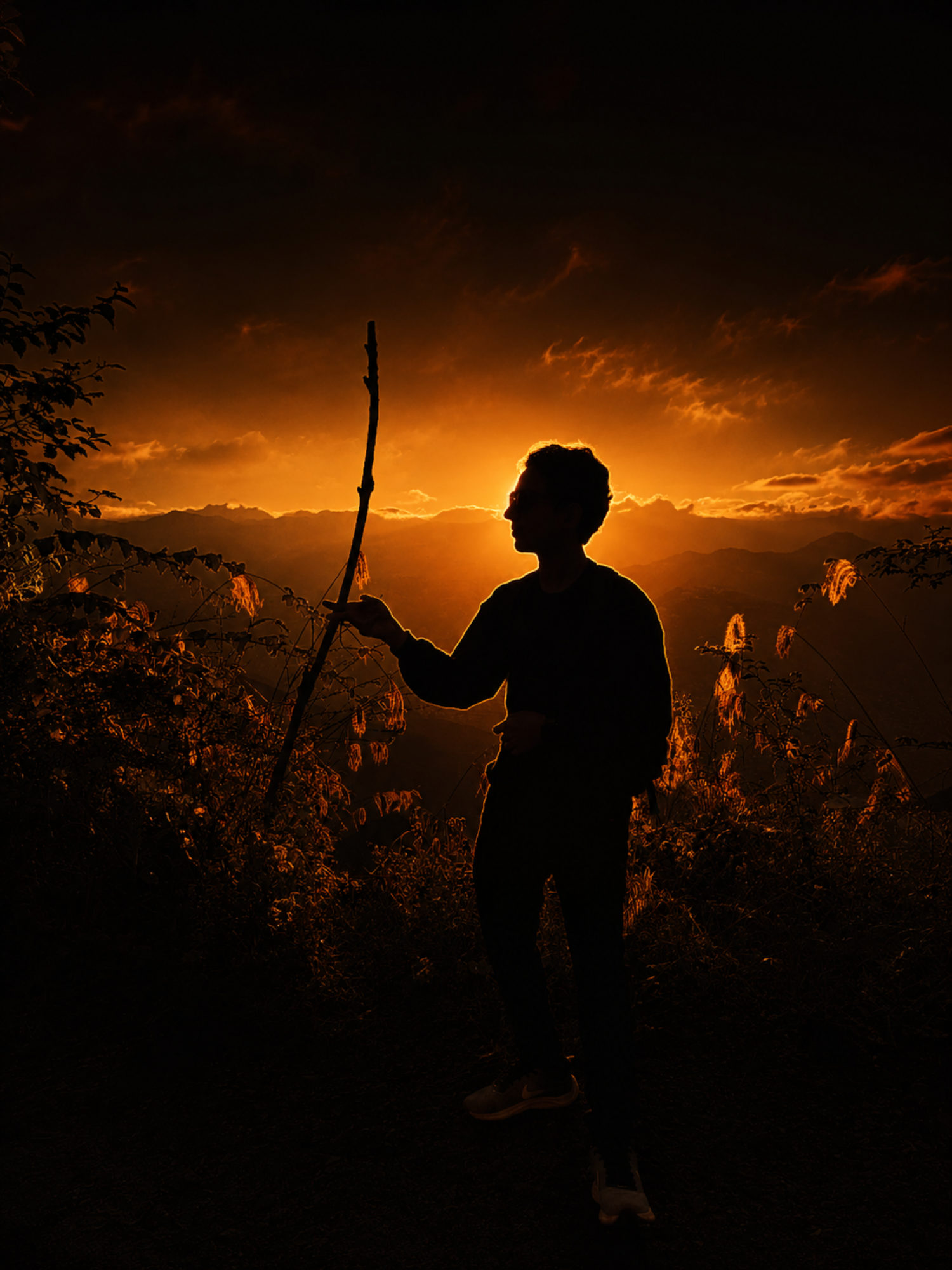 Sandesh Pandey standing on a Himalayan ridge at sunset